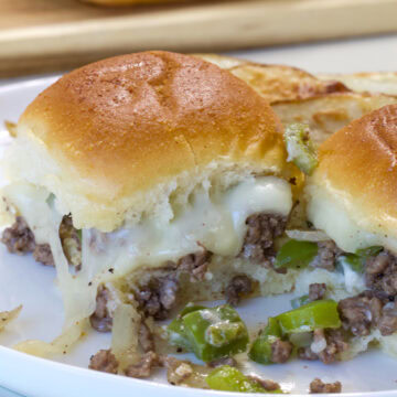 Close up of a Ground Beef Philly Cheesesteak Sliders so the melty provolone cheese is visible.
