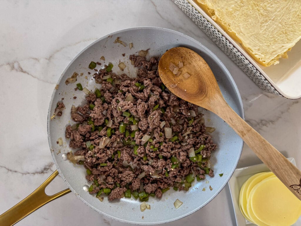 The ground beef mixture in the skillet after it's been cooked.