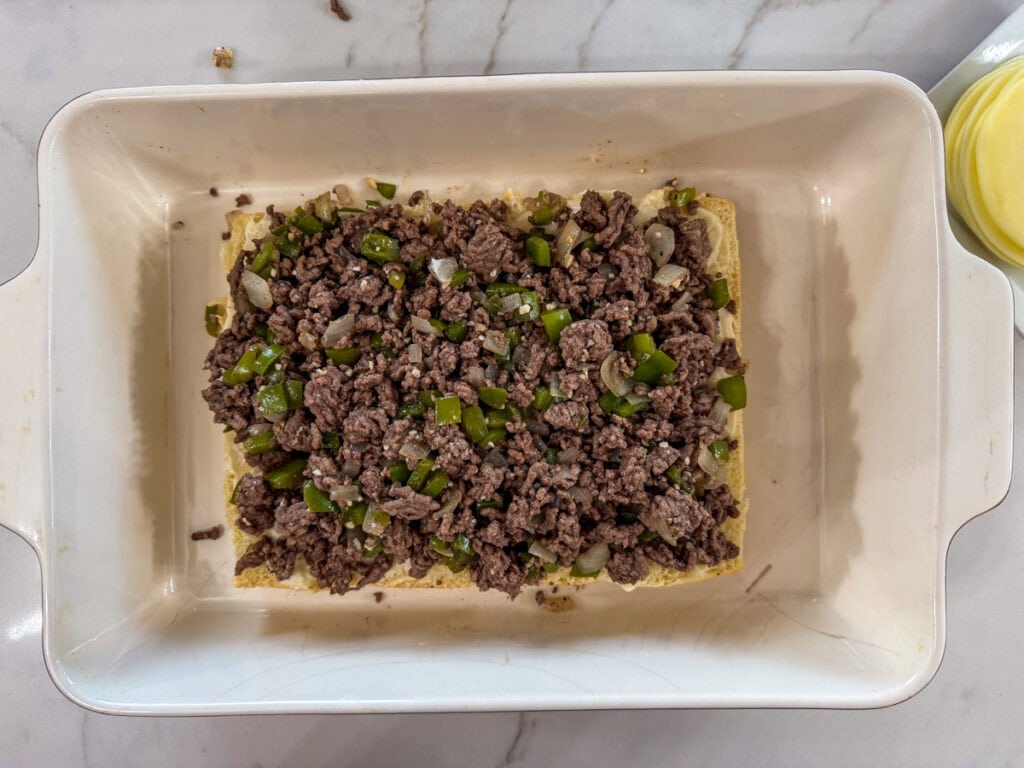 The beef mixture added to the buns on top of the mayo.