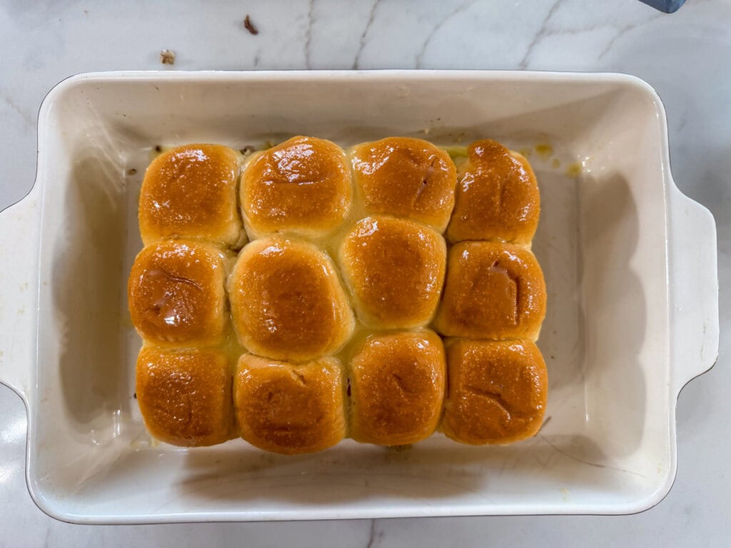The top buns added and the garlic butter brushed on the top of the rolls.