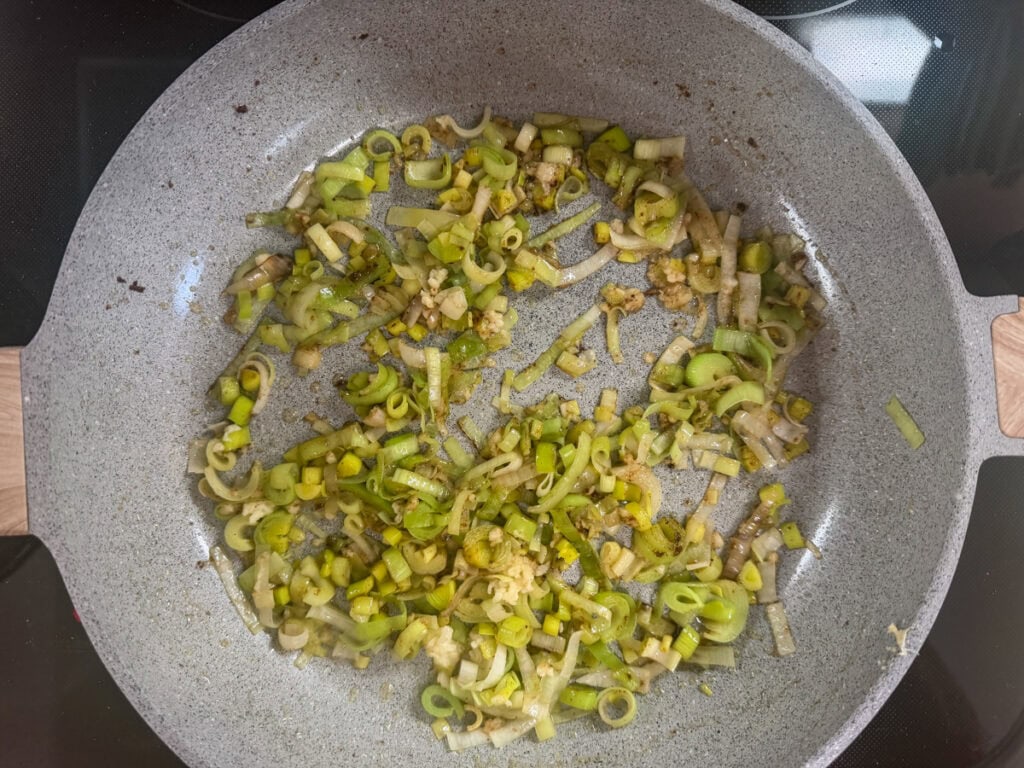 Sliced leeks and chopped garlic in a large skillet.