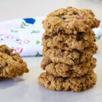 Close up of a stack of five Peanut Butter Cowboy Cookies with two cookies next to the stack.