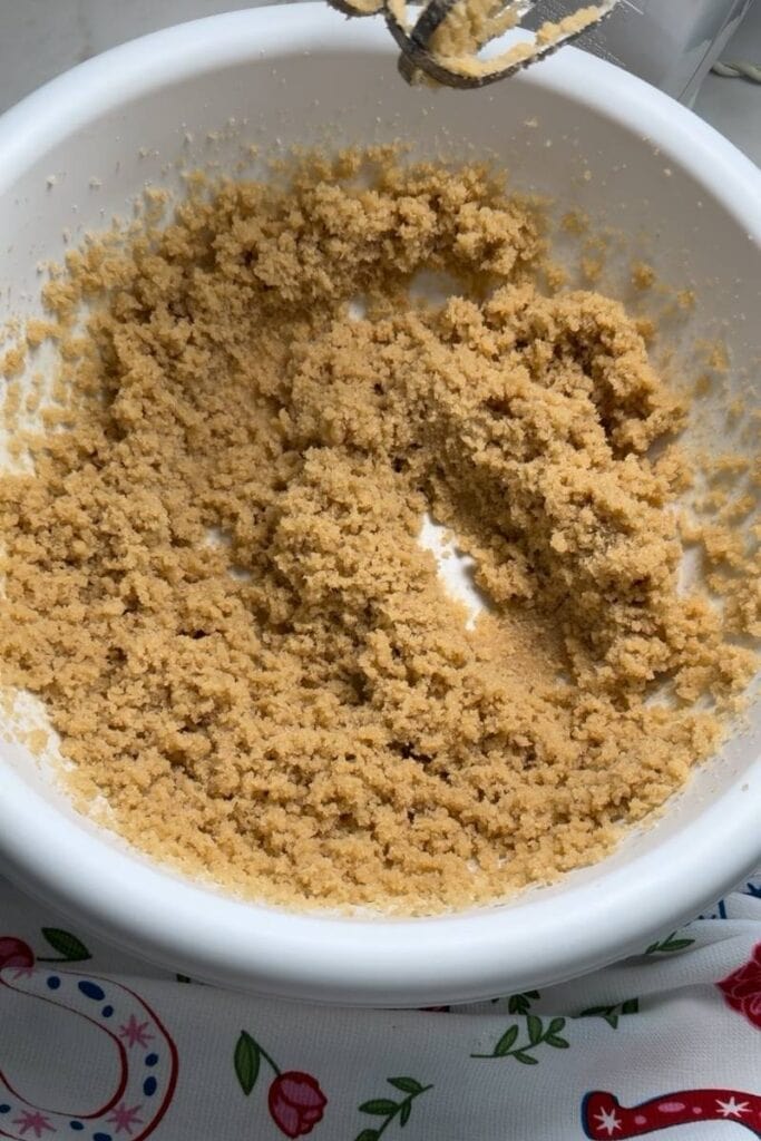 The butter and sugars creamed together in a mixing bowl.