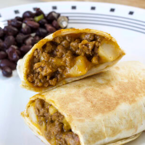 A burrito cut in half and the inside of both halves are visible.