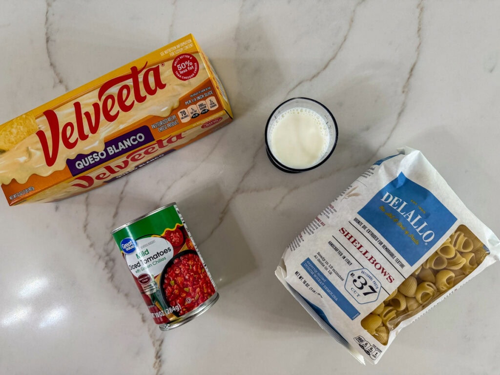 The velveeta, milk, pasta and can of diced green chiles used to make the Queso Blanco Mac and Cheese recipe.