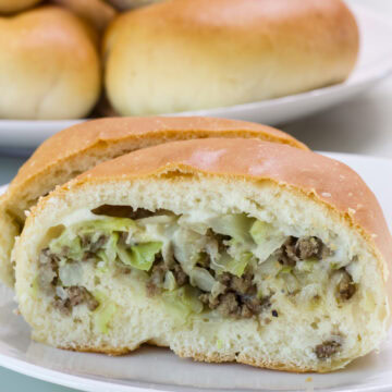 Very close up of a half bierock so the meat filling is visible.