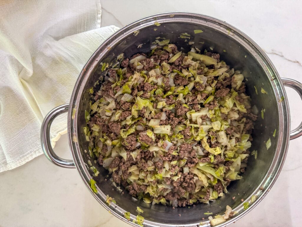 The cooked ground beef, cabbage and onion.