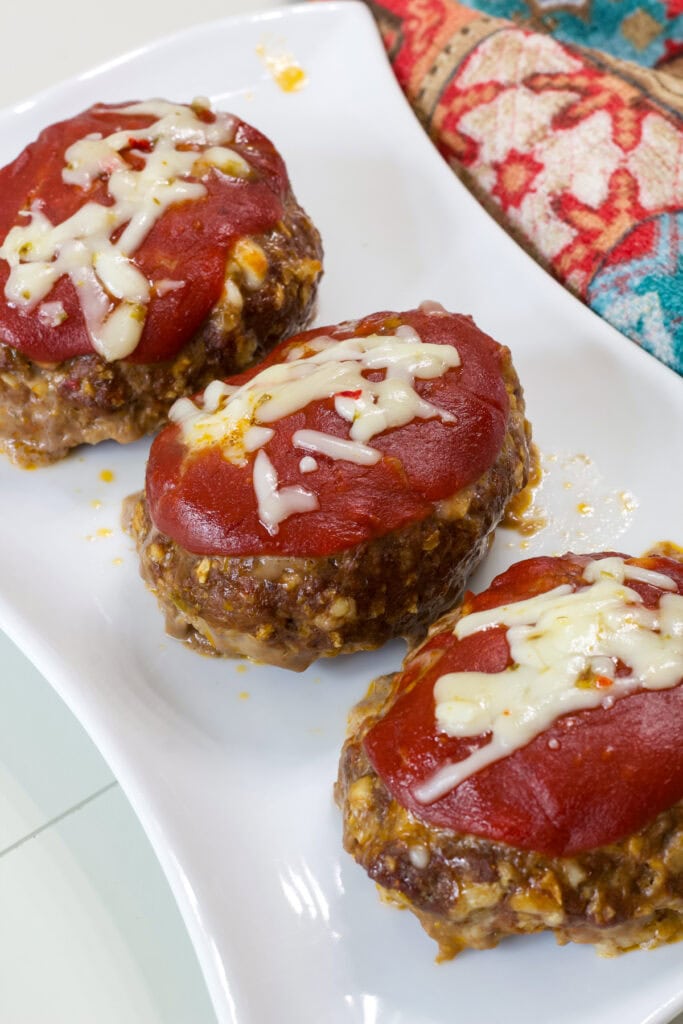 Three taco meatloaves on a white serving platter.