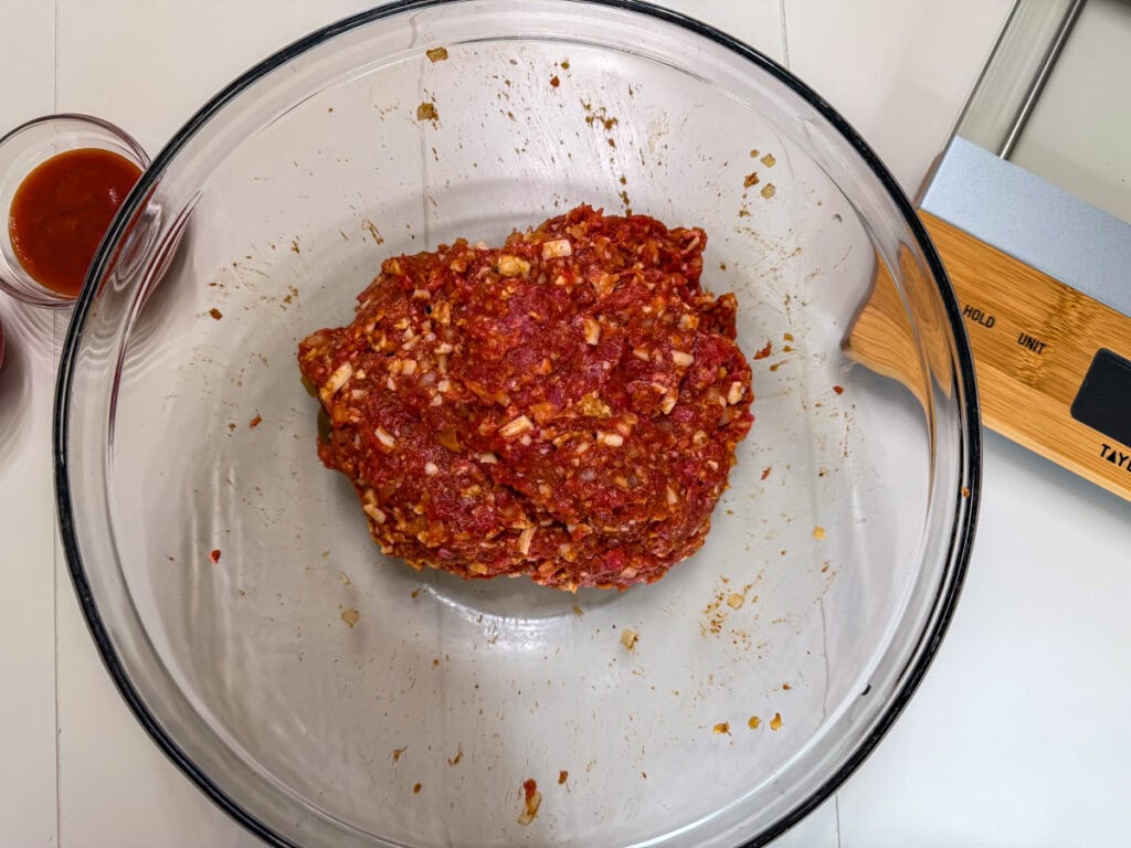 All of the taco meatloaf ingredients combined in a large glass bowl.