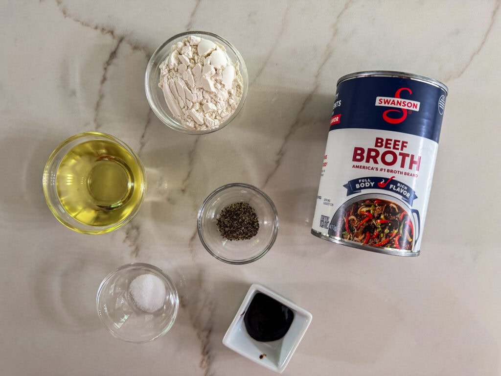 The oil, flour, broth, beef base, salt and black pepper measured out ready to make the brown gravy.
