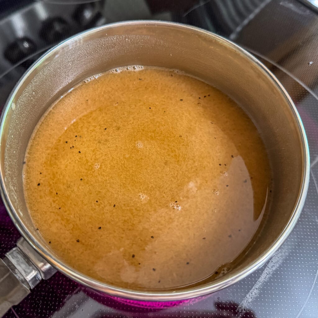 The beef broth and beef better than bouillon added to the roux in a small saucepan on the stove.