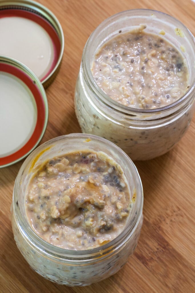 Two open jars of PB&J Overnight Oats after they've been refrigerated for eight hours.