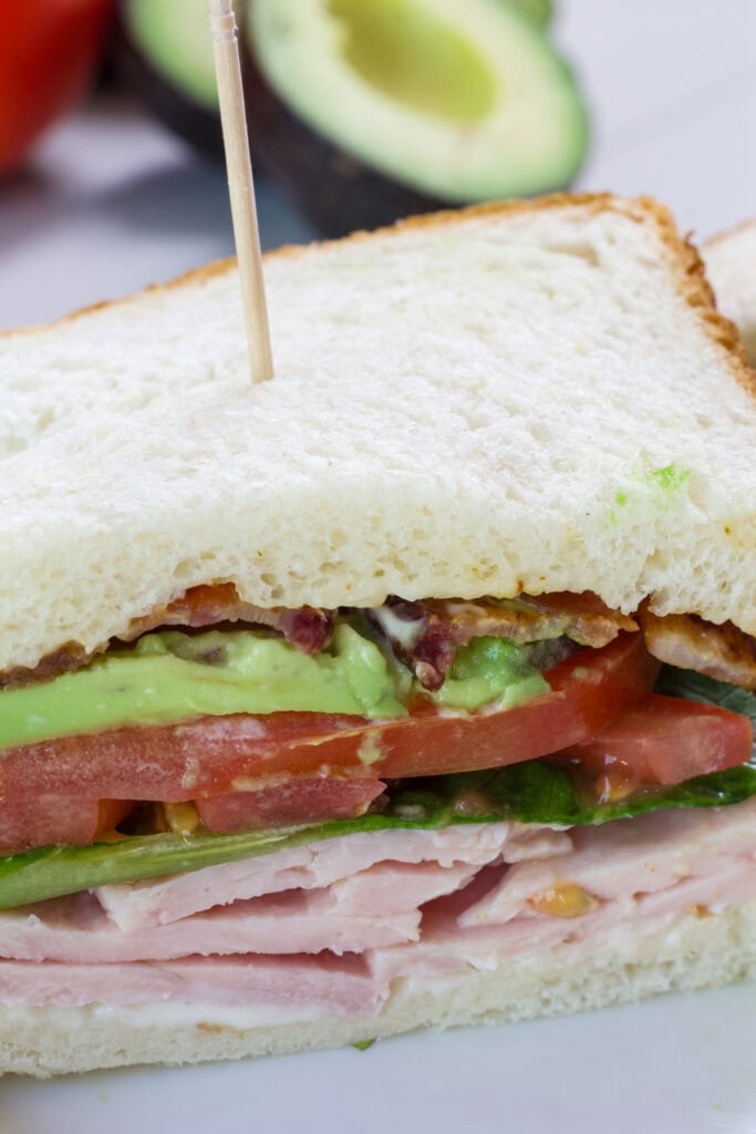Close up of a Panera turkey avocado blt so the inside layers are visible.