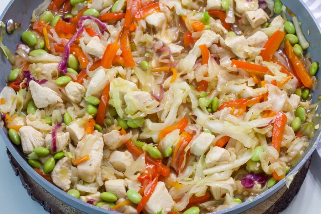 Close up of the chicken and cabbage stir fry in the skillet after it's been cooked.