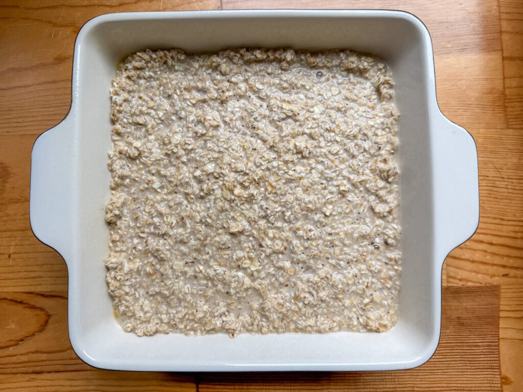 The oatmeal batter in the casserole dish before the cinnamon sugar topping is added.