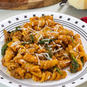 Closeup side view of one serving of One Pot Ground Beef Pasta on a plate.