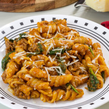 Closeup side view of one serving of One Pot Ground Beef Pasta on a plate.