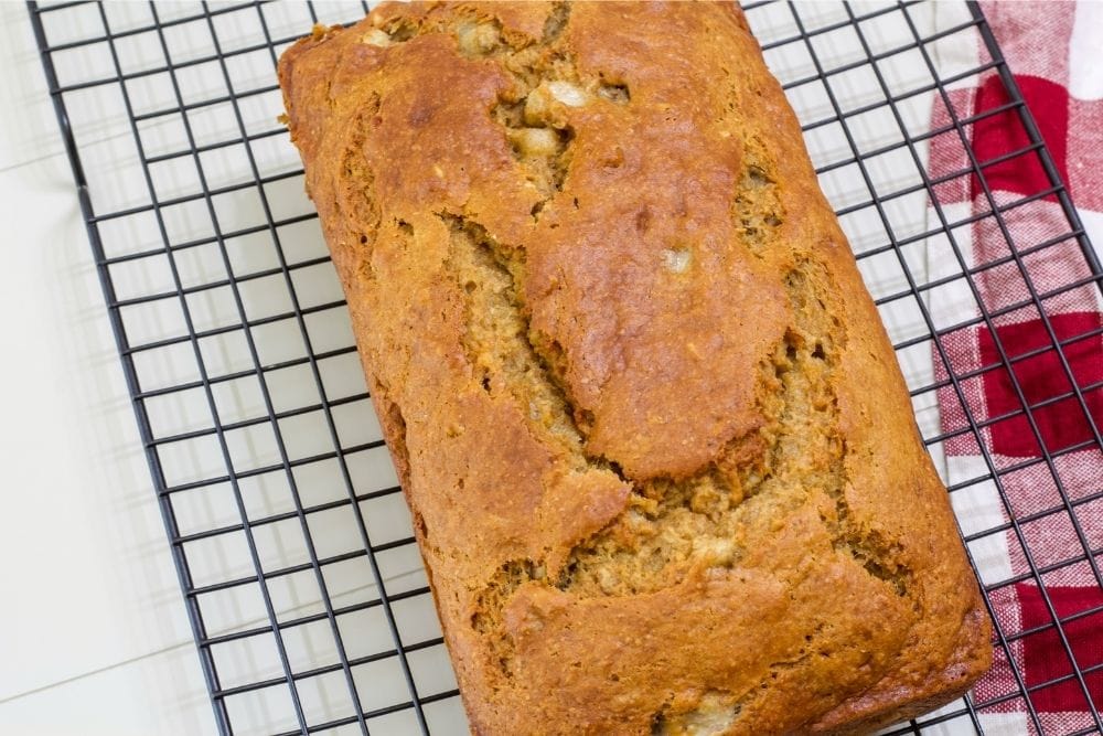 A whole loaf of Weight Watchers Banana Bread on a wire cooling rack.