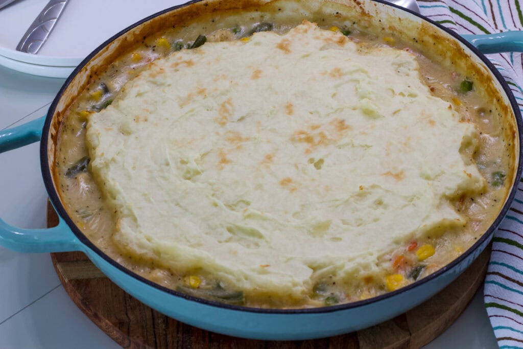 Side closeup of the entire Chicken Shepherd’s Pie in a pan.