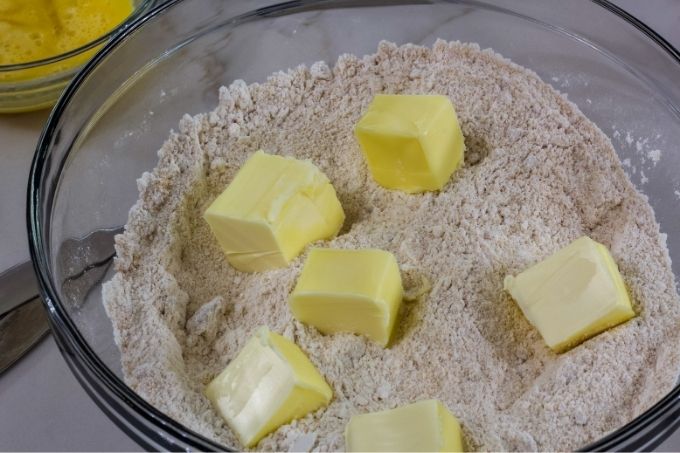 The butter cut in chunks in the dry mixture.