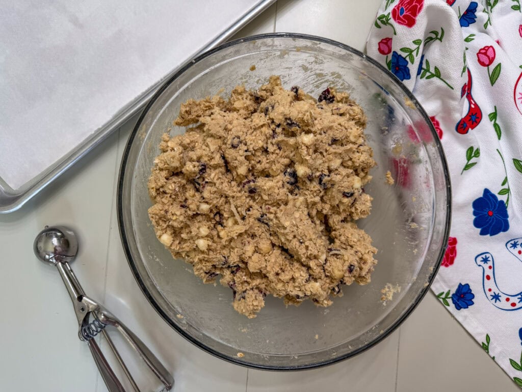 The cookie dough with the white chocolate chips, dried cranberries, oats, nuts and coconut added to it.