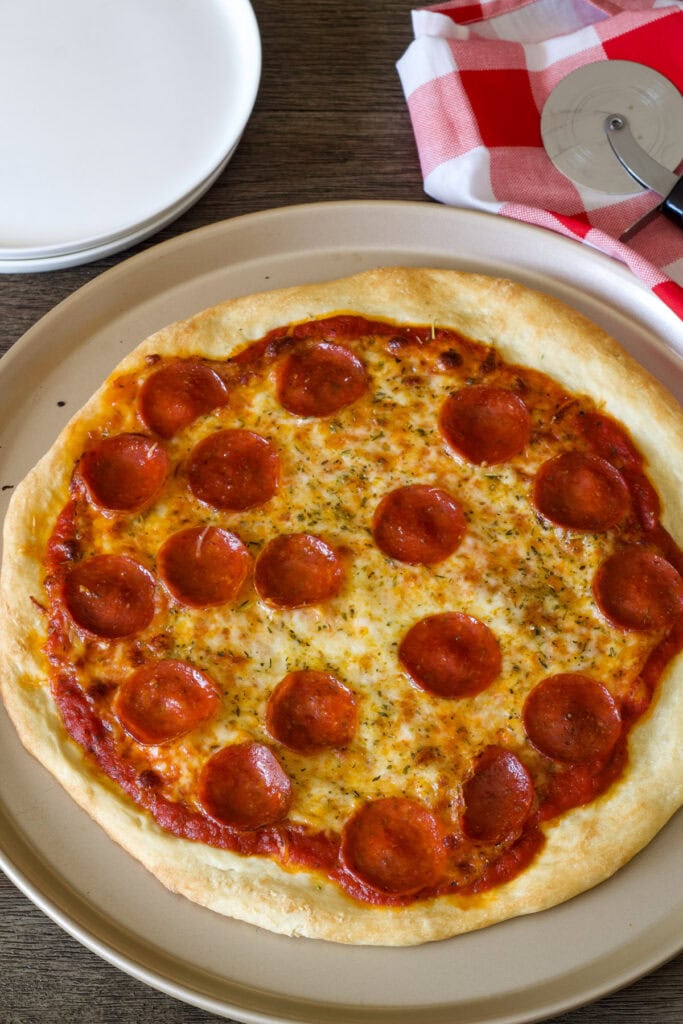 Overhead closeup of a whole uncut pepperoni pizza.