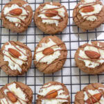 Nine Almond Joy Cookies on a wire cooling rack.