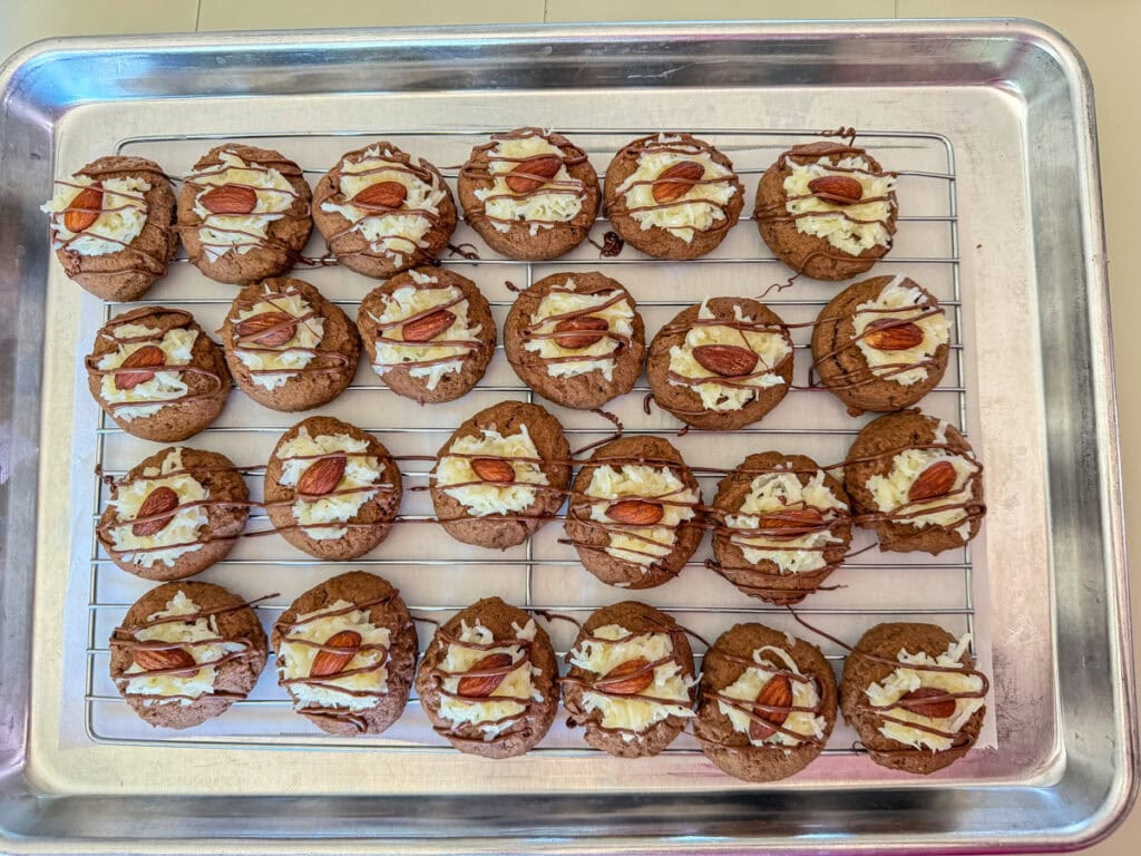 The finished almond joy cookies with the coconut topping, almond and drizzled with chocolate.