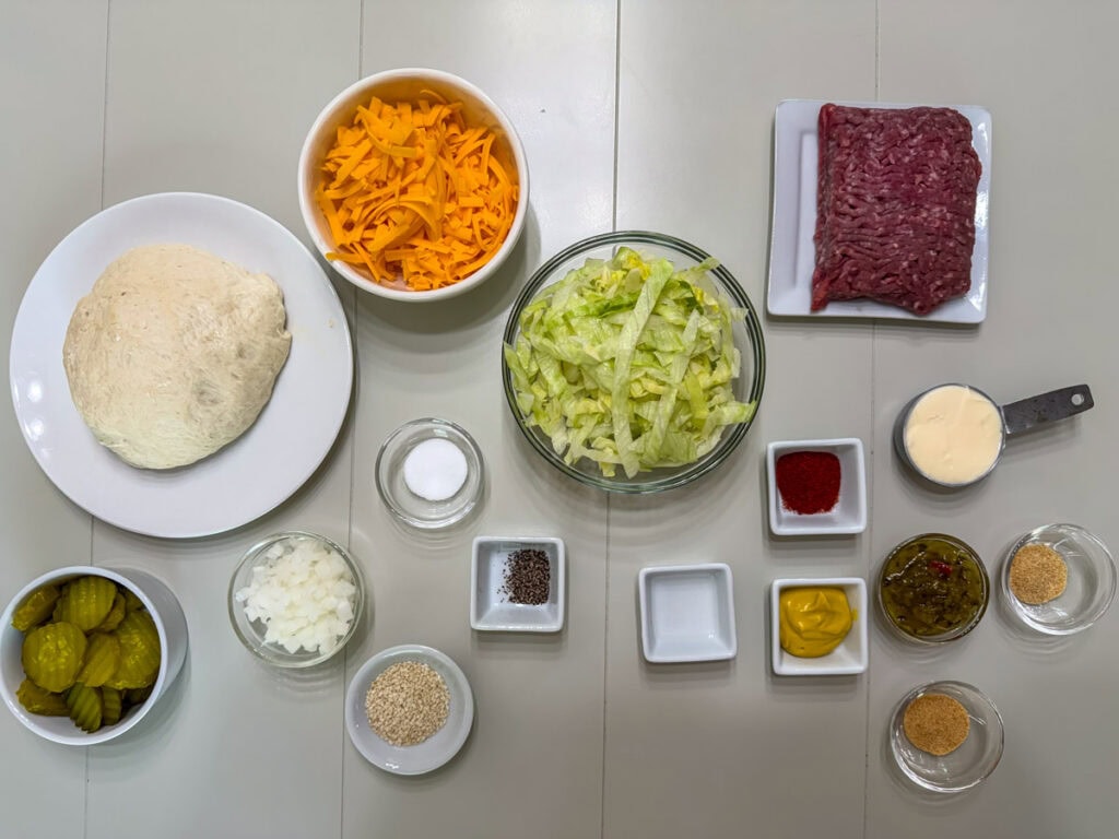 All of the ingredients measured out to make big mac pizza and special sauce.