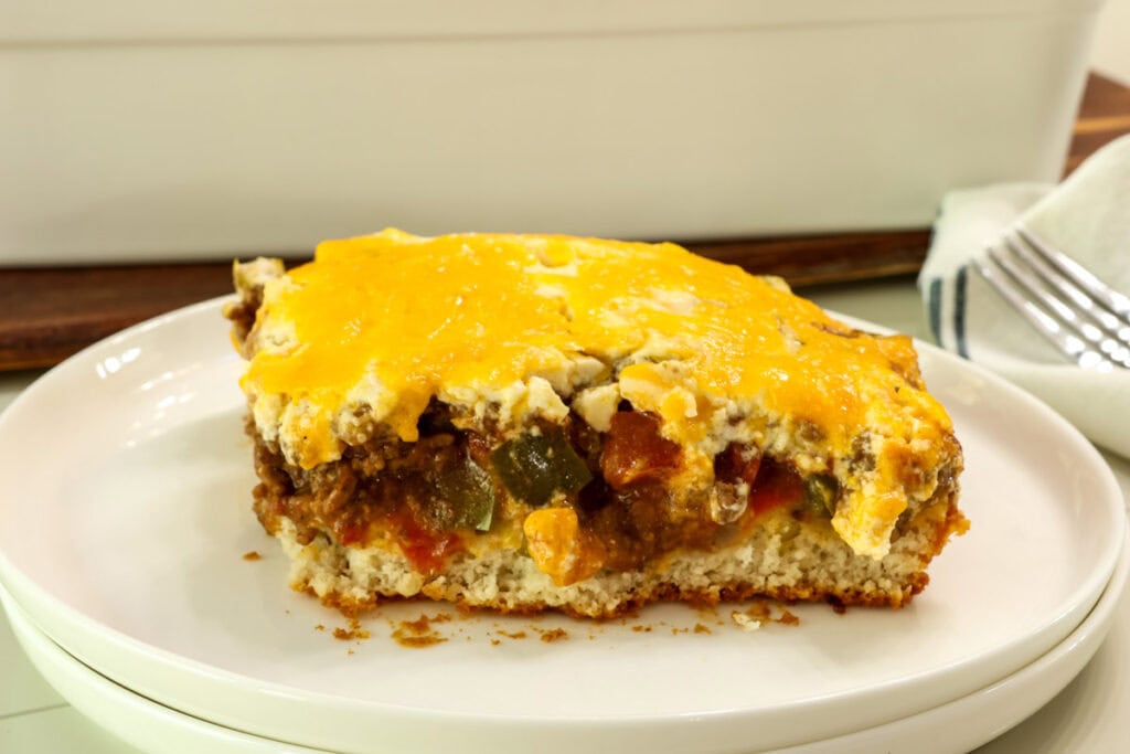 Side closeup of one serving of John Wayne Casserole on a white plate.