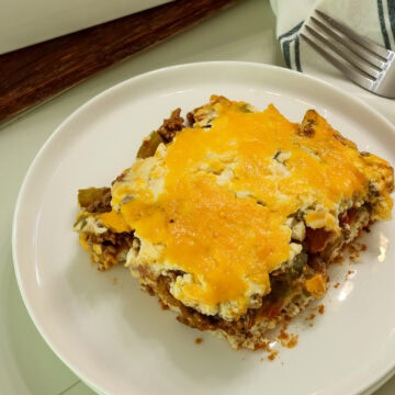 Overhead shot of one serving of John Wayne Casserole on a white plate.