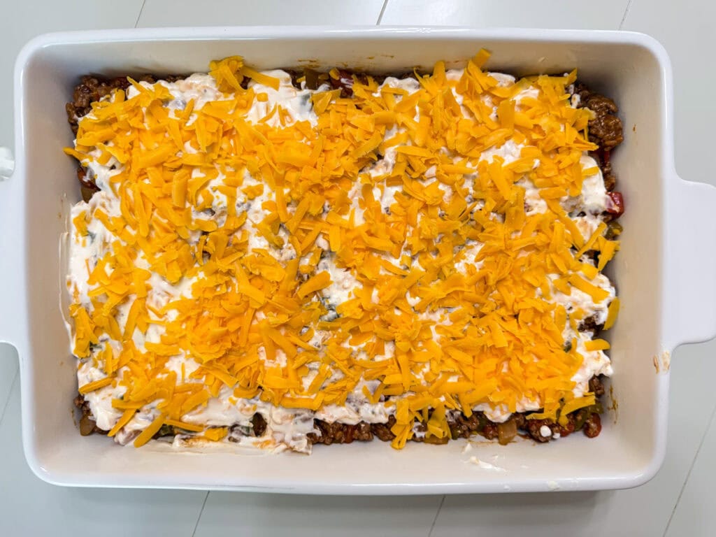 The shredded cheddar cheese added to the sour cream mixture.