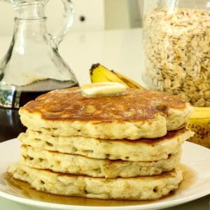 Very closeup side view of a stack of oatmeal banana pancakes.
