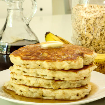 Very closeup side view of a stack of oatmeal banana pancakes.