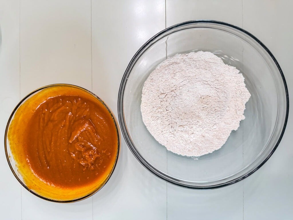 A medium bowl with the wet ingredients combined and a large bowl with the dry ingredients combined.