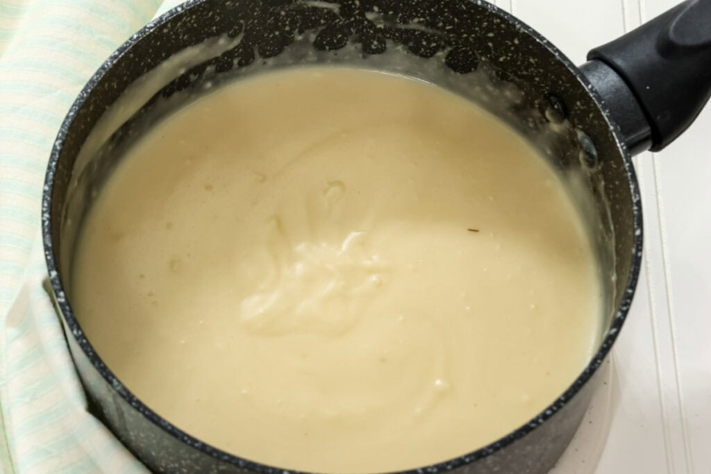 The homemade cream of chicken soup in a medium saucepan after it has been cooked.