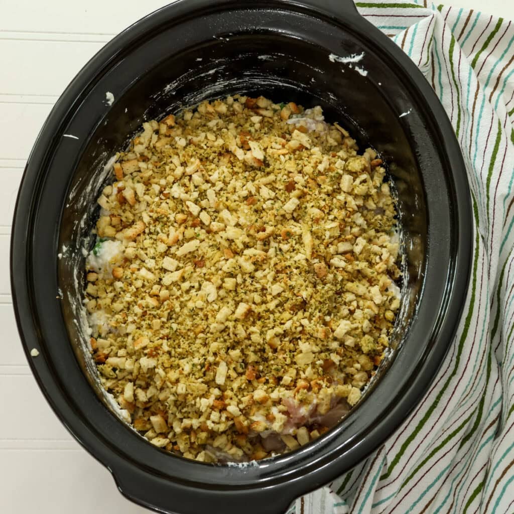 The stuffing and butter mixture added to the top of the chicken and vegetable mixture.